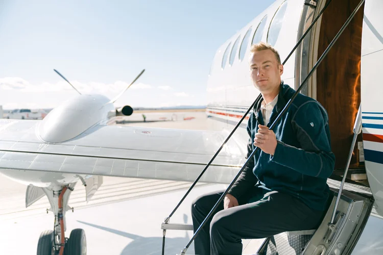 Skyroads captain stepping aboard a twin-turboprop aircraft on the ramp